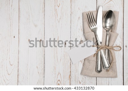Cutlery is in a napkin wrapped on an old table Royalty-Free Stock Photo #433132870
