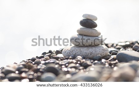 Pyramid of stones on the beach. Blurred background.