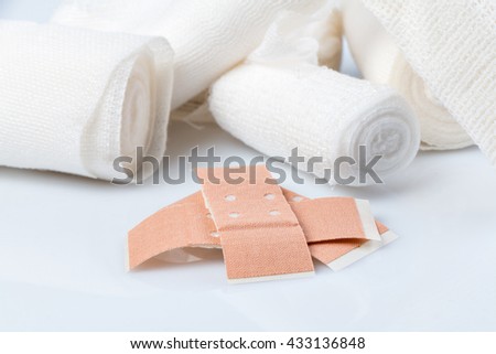 Plasters and bandages with Scissors and syringe on a white background Royalty-Free Stock Photo #433136848