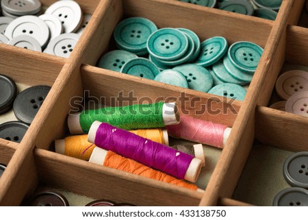 many collected colorful buttons in a box
