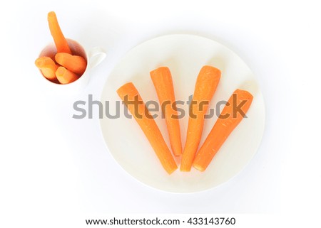 Fresh carrot on a white plate isolated on white background