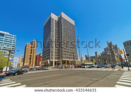 Municipal Services Building and skyscrapers in Philadelphia, Pennsylvania, USA. It is central business district in Philadelphia. Road view. Tourists in the street.