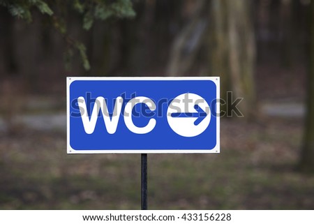 the signpost toilet on a blurred background