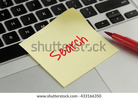 Search sticky note pasted on the keyboard
