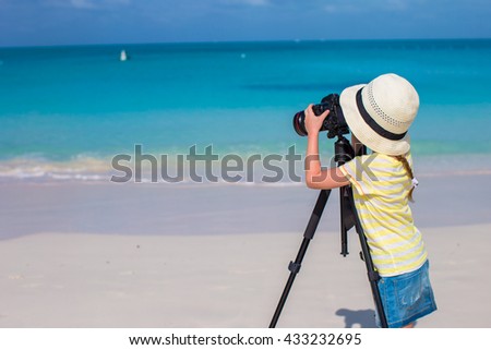 Little girl making video or photo with mobile phone
