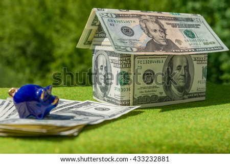 Cottage made of dollar banknotes, housing loan. Think green. Collect money for ecological house,