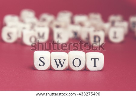 Swot word written on wood cube with red background