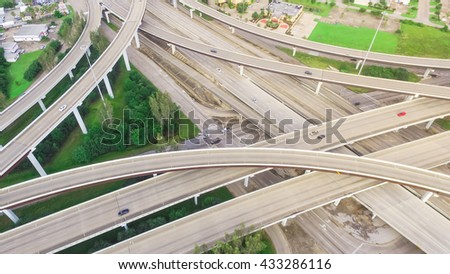 Aerial view massive highway intersection, stack interchange with elevated road junction overpass at early morning in Houston, Texas. This five-level freeway interchange carry heavy traffic, panorama.