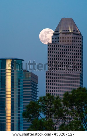 A super moon/full moon rising behind the Enron skyscrapers in Houston, TX