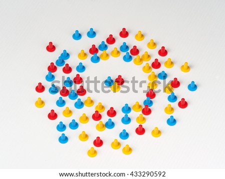 Random group colored plastic hat shaped parts red, blue and yellow on white with three in the center