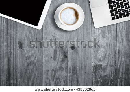 digital tablet pc, computer and cup of coffee on wooden table