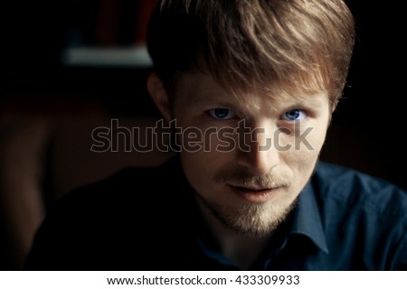 boy with blue eyes looking at photographer
