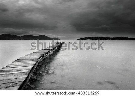Beautiful long exposure seascape view with wooden jetty in black and white at Marina Island, Lumut Perak Malaysia. Nature composition.