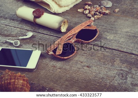 Travel items on wooden table. Summer time sea vacation background. Top view with copy space
