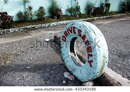 Drive Safely written in old white tire