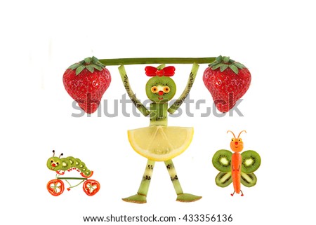 Creative food concept. Funny little girl  with slices of kiwi. 