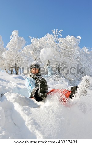 young beautiful woman playing in the snow