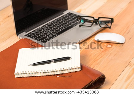 Blank business cards with supplies on wooden office table
