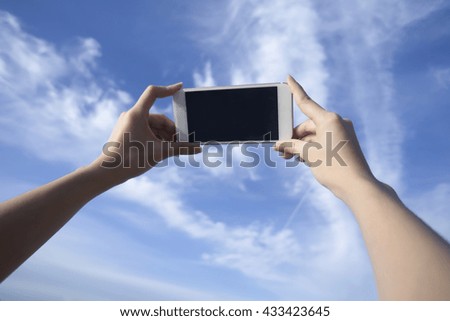 woman use smart phone take a photo of blue sky and beautiful cloud , isolate black monitor