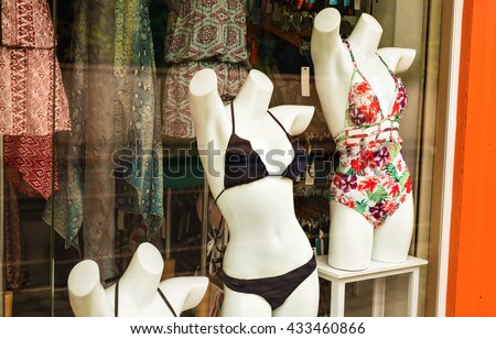 Women's swimsuits on mannequins for sale at a seaside shop