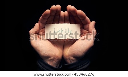 A man holding a torn piece of paper with a Liability Concept