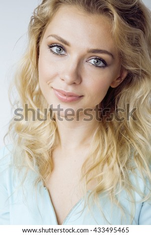 young pretty blond woman smiling on white background close up makeup, lifestyle people concept
