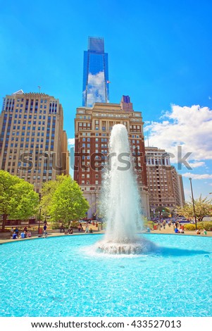 Fountain in Love Park of Philadelphia, in Pennsylvania, USA. Tourists in the park. Skyline with skyscrapers on the background
