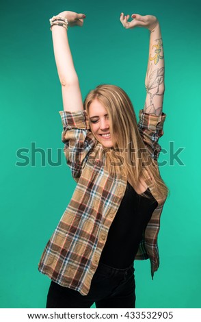 Happy and smiling teenage girl on a blue background