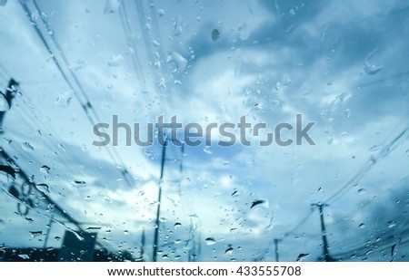abstract view from the window at the rain, thunder and lightning with drops on the glass, soft focus and vintage color