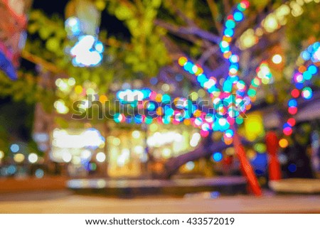 Blur image of tourists walk in night market