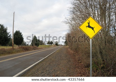 Deer Elk Crossing Road Sign in a contry rura street road