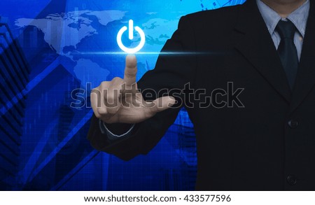 Businessman pressing power button over map and city tower, Elements of this image furnished by NASA