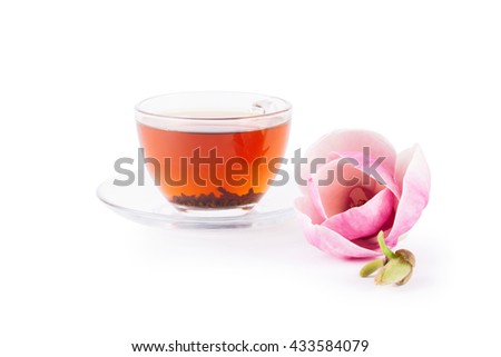 Cup of tea with pair pink magnolia flower on white background