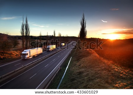 Truck transportation on the road at sunset Royalty-Free Stock Photo #433601029
