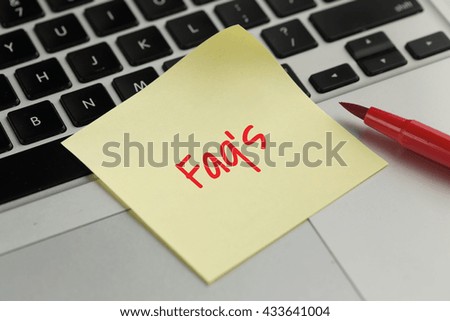 Faq's sticky note pasted on the keyboard