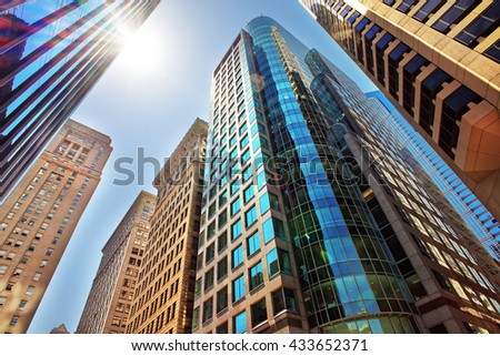 Bottom-up view to skyscrapers mirrored in glass in Philadelphia, Pennsylvania, USA. It is central business district in Philadelphia