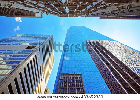 Bottom up view on skyscrapers mirrored in glass in Philadelphia, Pennsylvania, USA. It is central business district in Philadelphia
