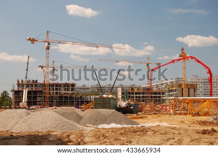 Construction cranes on a blue sky background Royalty-Free Stock Photo #433665934