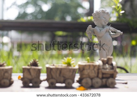 Small tree in pot decor on garden background
