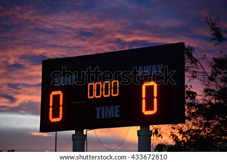 scoreboard with home and guests written on it at sunset time. Royalty-Free Stock Photo #433672810