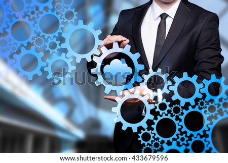 Glowing gear with icon "Cloud Technology" in the hands of a businessman. Business concept. Internet concept.