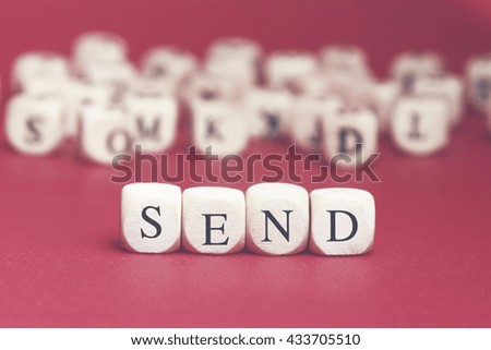 Send word written on wood cube with red background