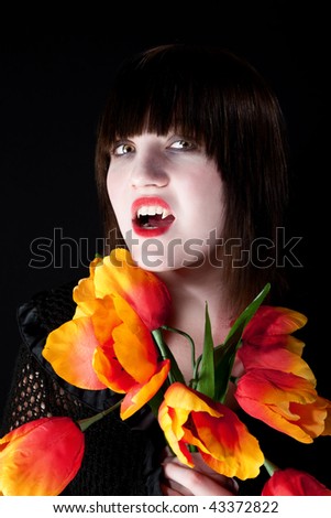 Pretty young vampire with bright plastic flowers