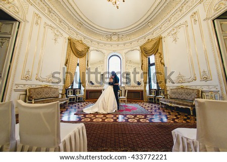 Beautiful luxury newlyweds in the museum Royalty-Free Stock Photo #433772221
