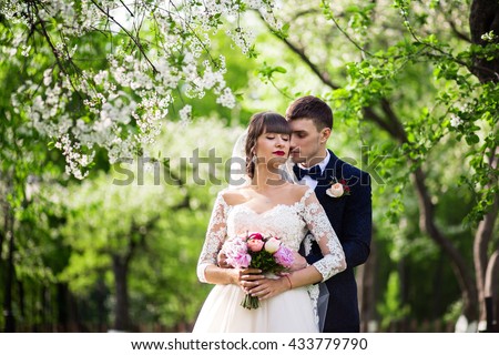 bride and groom in blooming gardens