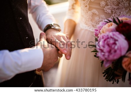 hands of bride and groom Royalty-Free Stock Photo #433780195
