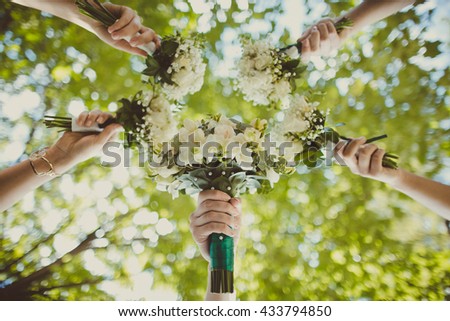 fragile bride and her girlfriends kept small bouquets of flowers
