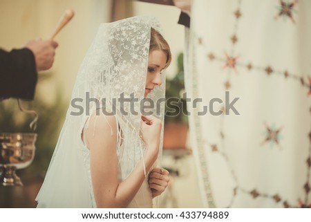 gorgeous young  bride praying in church