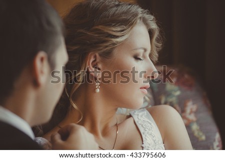 groom  admires his charming wife
