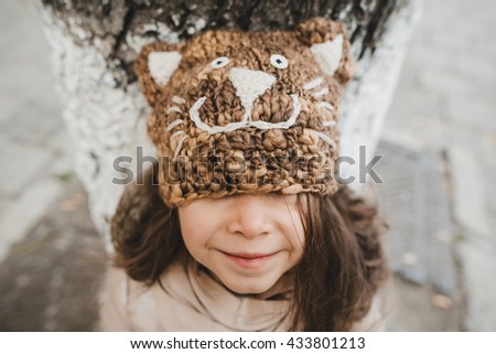 girl in a funny in brown hat with ears